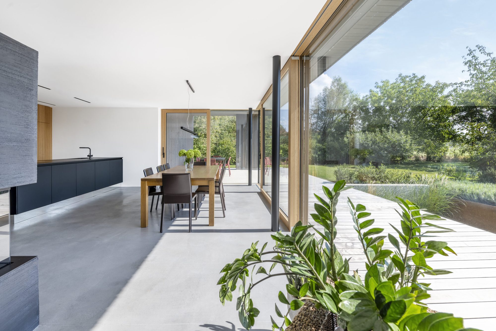 Open lift-slide door connecting living space to garden